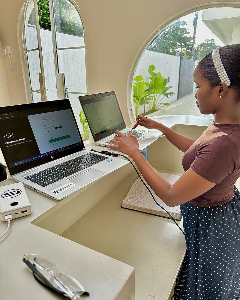 A cashier using DukaSuite at a shop counter