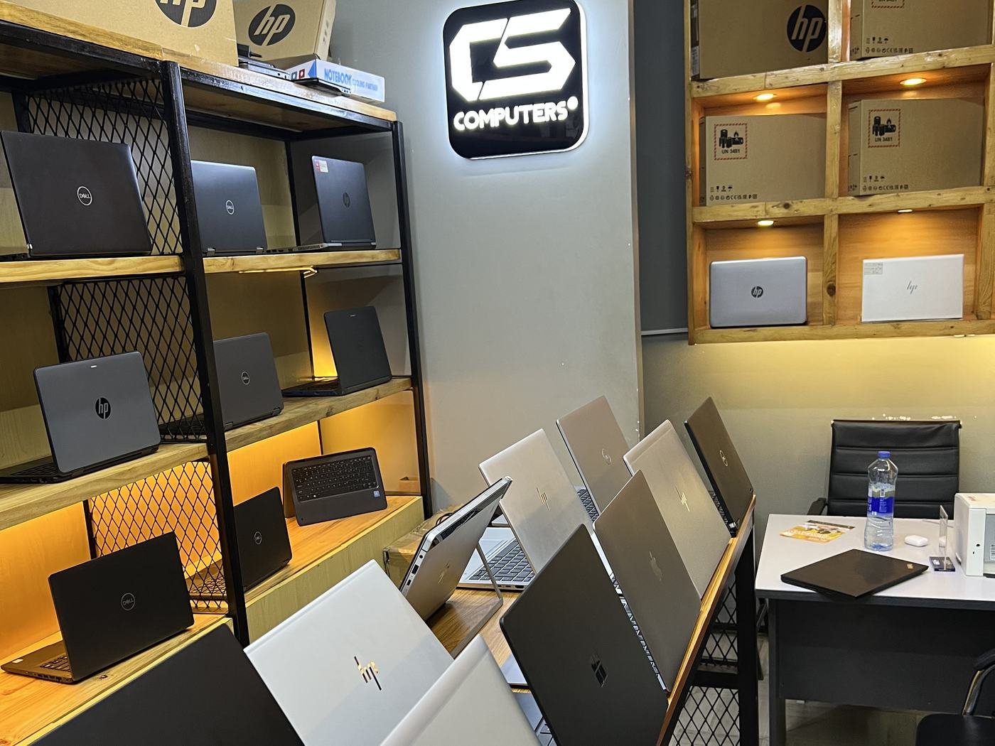 Rows of HP and Dell laptops on display inside the CS Computers shop