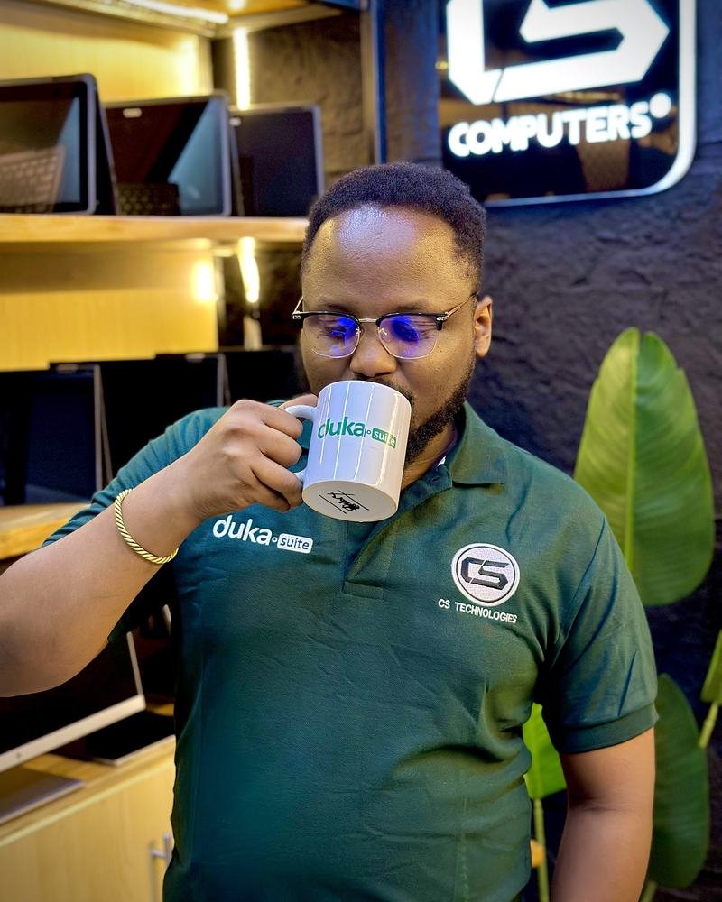 A DukaSuite team member drinking from a DukaSuite mug