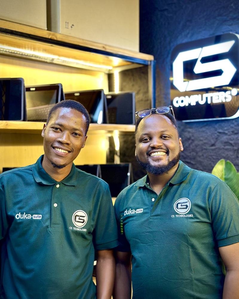 Two DukaSuite team members smiling in the shop