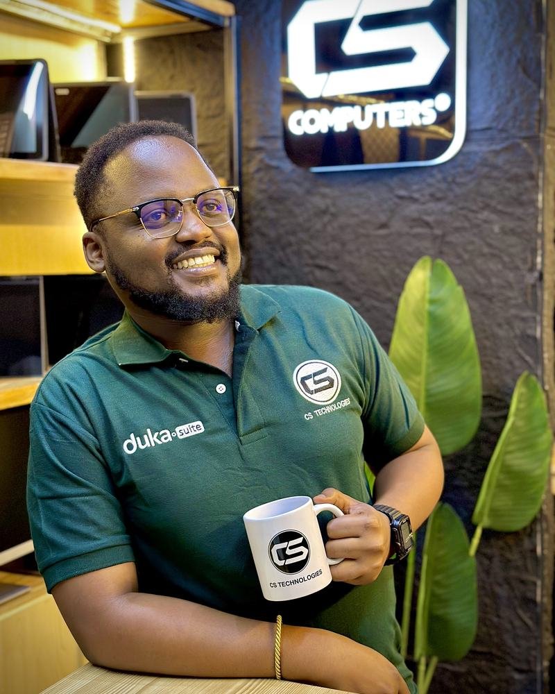 A DukaSuite team member holding a CS mug